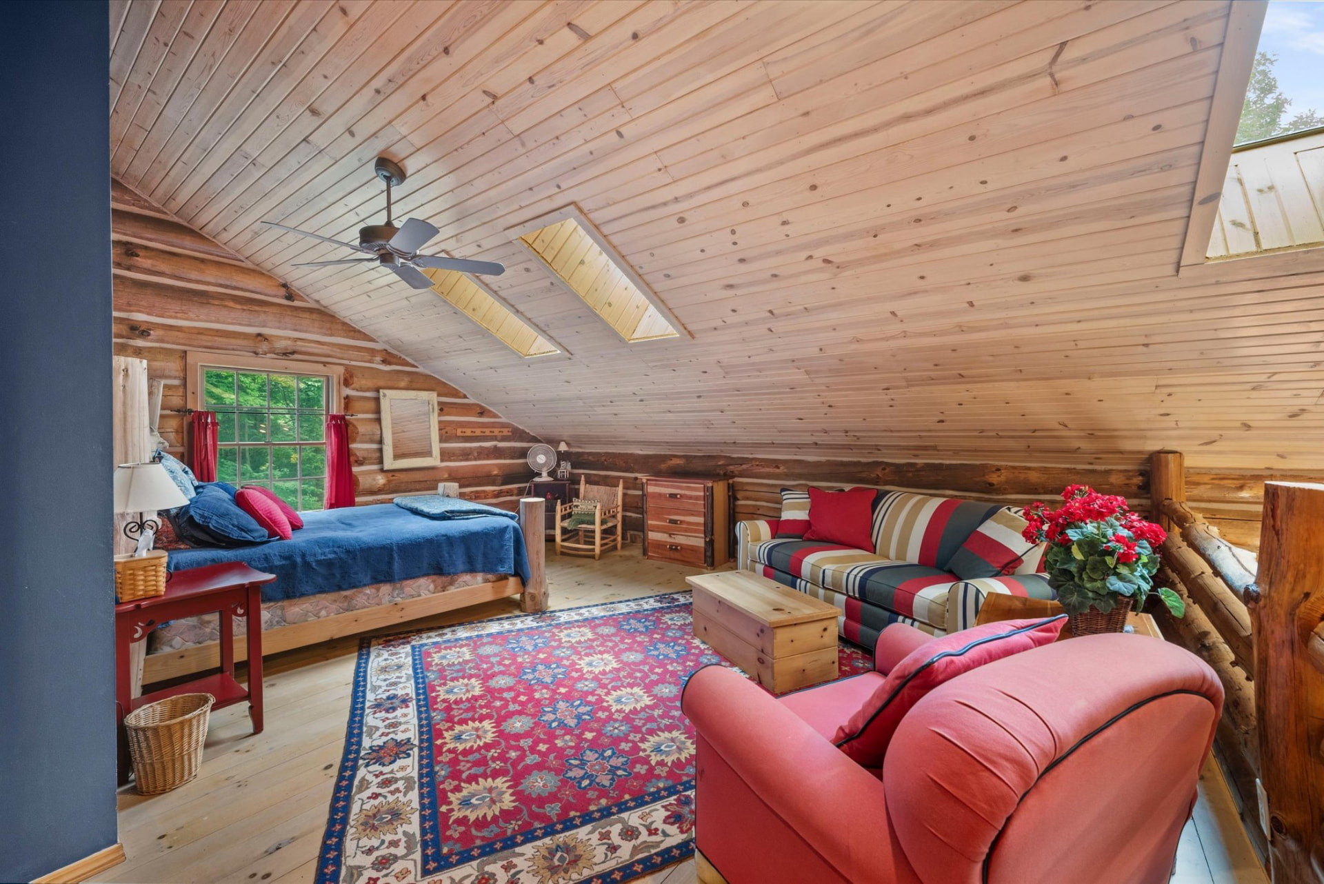 Skylit upper-level bedroom and sitting area