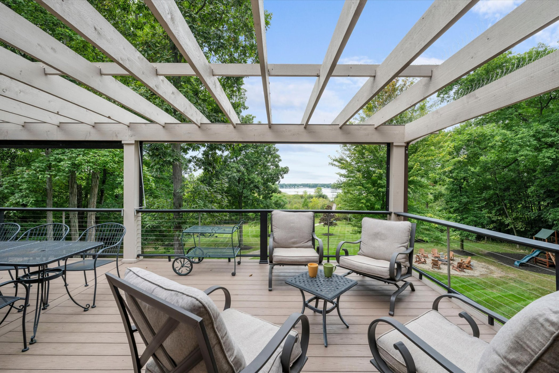 Pergola-covered deck overlooking the lawn and Little Long Lake